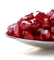 pomegranate seeds macro against a white background