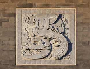 brick wall with carved phoenix slabstone