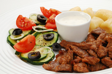 Grilled meat, dumplings and vegetable salad
