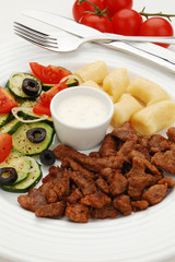 Grilled meat, dumplings and vegetable salad