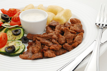 Grilled meat, dumplings and vegetable salad