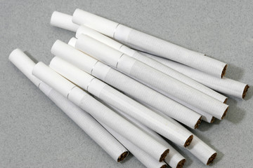 Cigarettes with white filters isolated on grey background