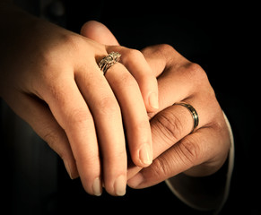Hands of bride and groom together