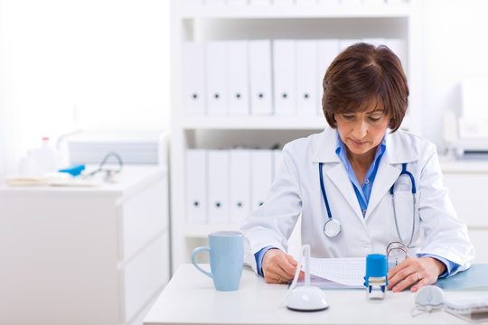 Female doctor working at office