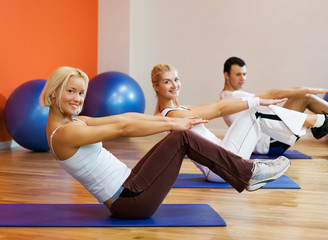 Group of people doing fitness exercise with a ball
