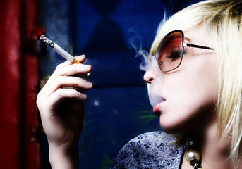 The beautiful girl smokes a cigarette