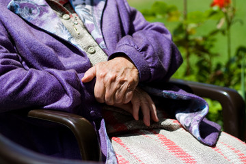 Elderly Woman in sunlight siting