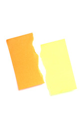 Torn yellow and orange postits.