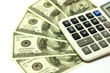 Fototapeta premium One hundred dollar banknotes and calculator