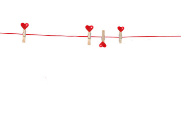 Several Pegs with little red hearts hanging from Clothes-Line