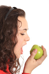 Portrait of a young girl eating an apple