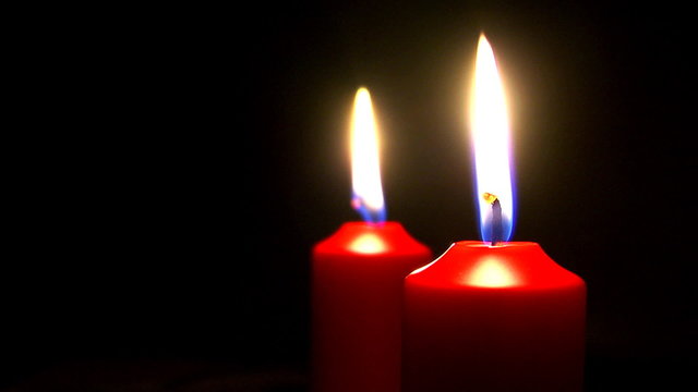 Two Candles in blackness