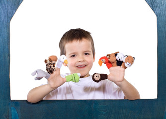 Smiling kid playing with puppets