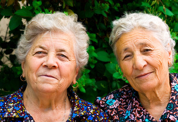Two happy old women smiling outdoor