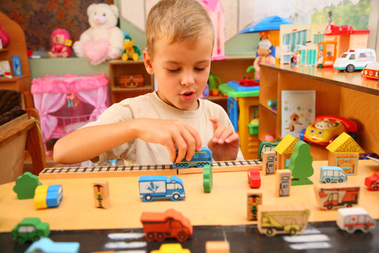 Boy plays with toy  in playroom