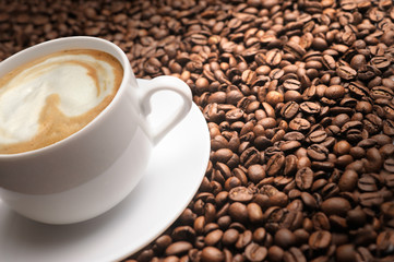 Coffee cup on coffe beans