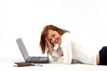 Woman working on laptop and smiling