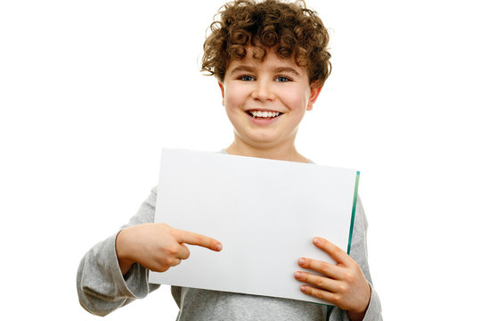 Boy Holding Blank Sheet Of Paper Isolated On White Background