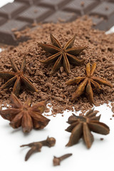 anise stars, grated chocolate and chocolate plate