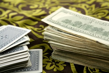 dollar notes and poker cards, gambler tools © lunamarina