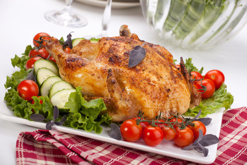 Whole roasted chicken on table