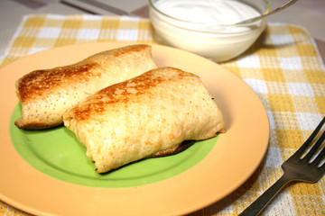 Pancakes with meat and sour cream