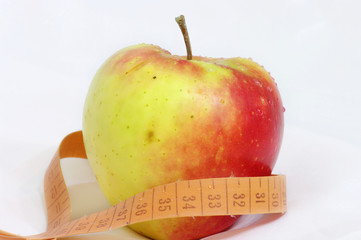 apple and measuring tape isolated on white background