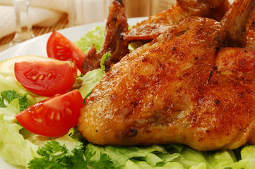 Grilled chicken wings with baked potatoes and vegetable salad
