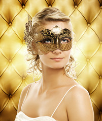 Beautiful woman in carnival mask over abstract background