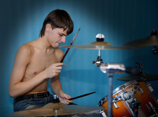 A young male drummer in action