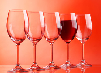 Wine glasses on red background