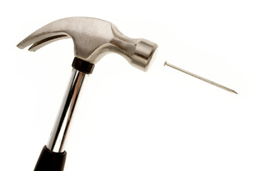 Hammer and nail on white