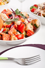 bowl of panzanella bread salad and two other salads at the back