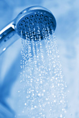 Naklejka na ściany i meble water flowing from metal shower