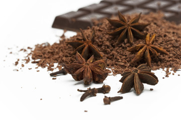 anise stars, grated chocolate and chocolate plate