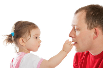 Little girl feeding dad