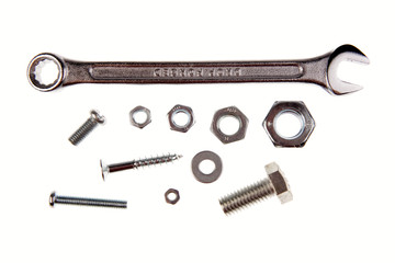 Spanner, nuts and bolts on white