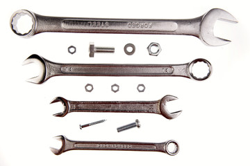 Spanners, nuts and bolts on white