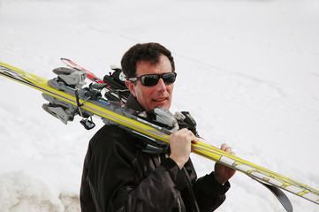 Man carrying skis
