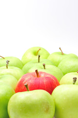 red apple among green apples