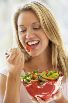 Young Woman Eating Salad