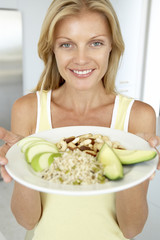 Mid Adult Woman Holding Plate With Healthy Foods