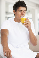 Fototapeta premium Young Man Drinking Orange Juice