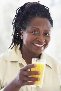 Senior Woman Drinking Fresh Orange Juice