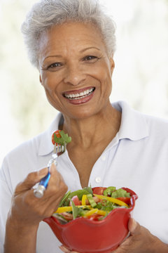 Senior Woman Eating A Fresh Green Salad