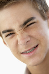 Obraz premium Portrait Of Teenage Boy Looking Grumpy