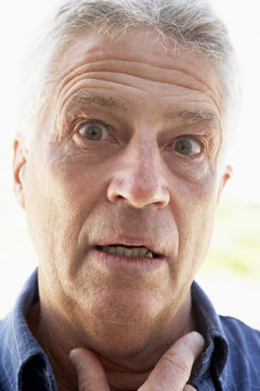 Portrait Of Senior Man Looking Shocked