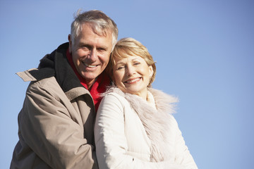 Senior Couple Embracing In Park