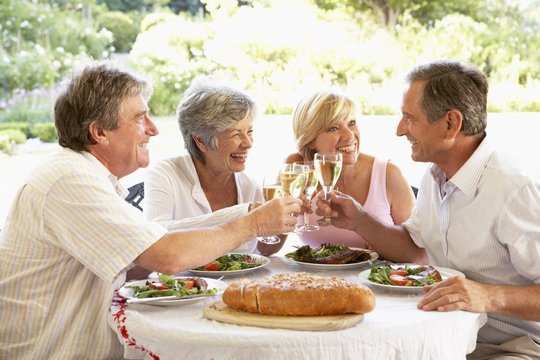 Friends Eating An Al Fresco Lunch, Holding Wineglasses