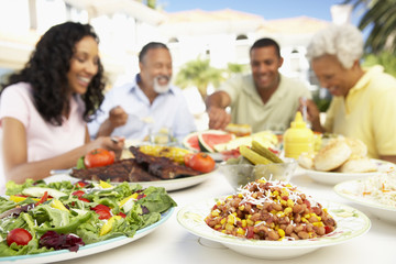 Naklejka premium Family Eating An Al Fresco Meal